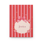 Candy Cane personalized journal open flat showing custom name on red and pink striped cover with bow illustration
