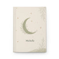 Celestial Moon personalized journal open flat showing custom name on sage-green cover with crescent moon illustration