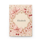 Cherry Blossom personalized journal open flat showing custom name on cover with pink floral and bow illustration