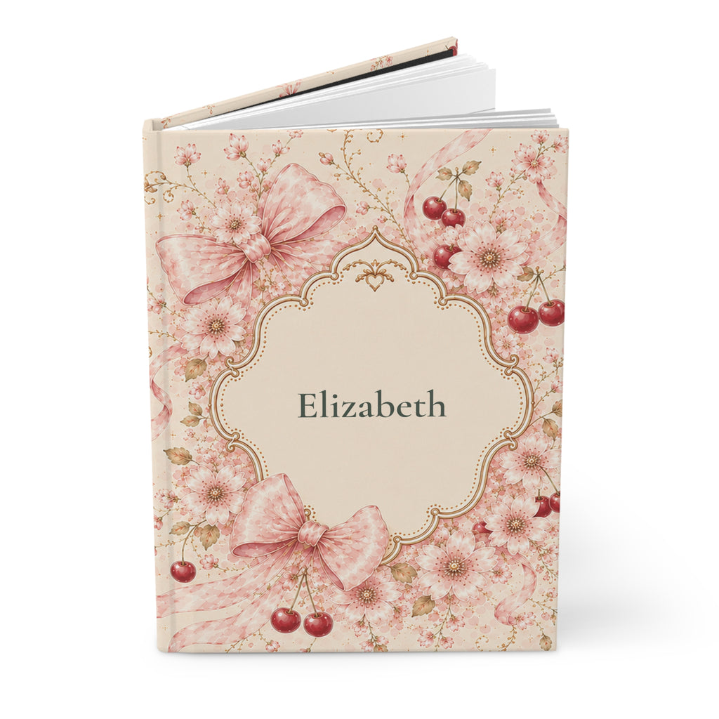 Close-up of the Cherry Blossom journal cover showing floral bow illustration and personalized name