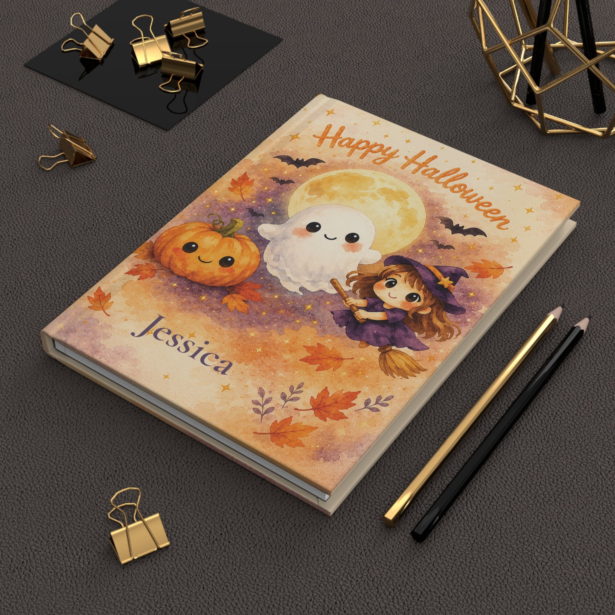 Happy Halloween journal held in hand to show size and portability