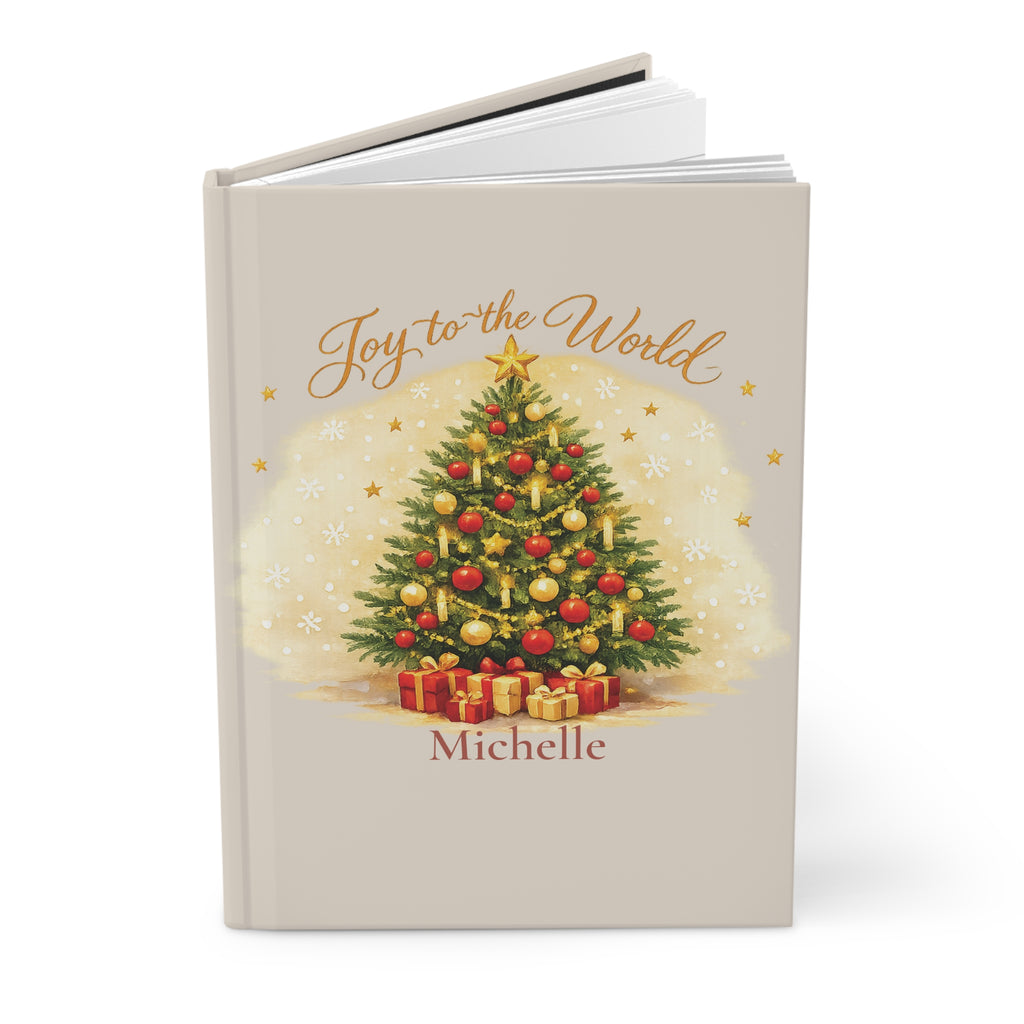 Close-up of the Joy to the World journal cover showing Christmas tree illustration and personalized name