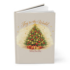 Close-up of the Joy to the World journal cover showing Christmas tree illustration and personalized name