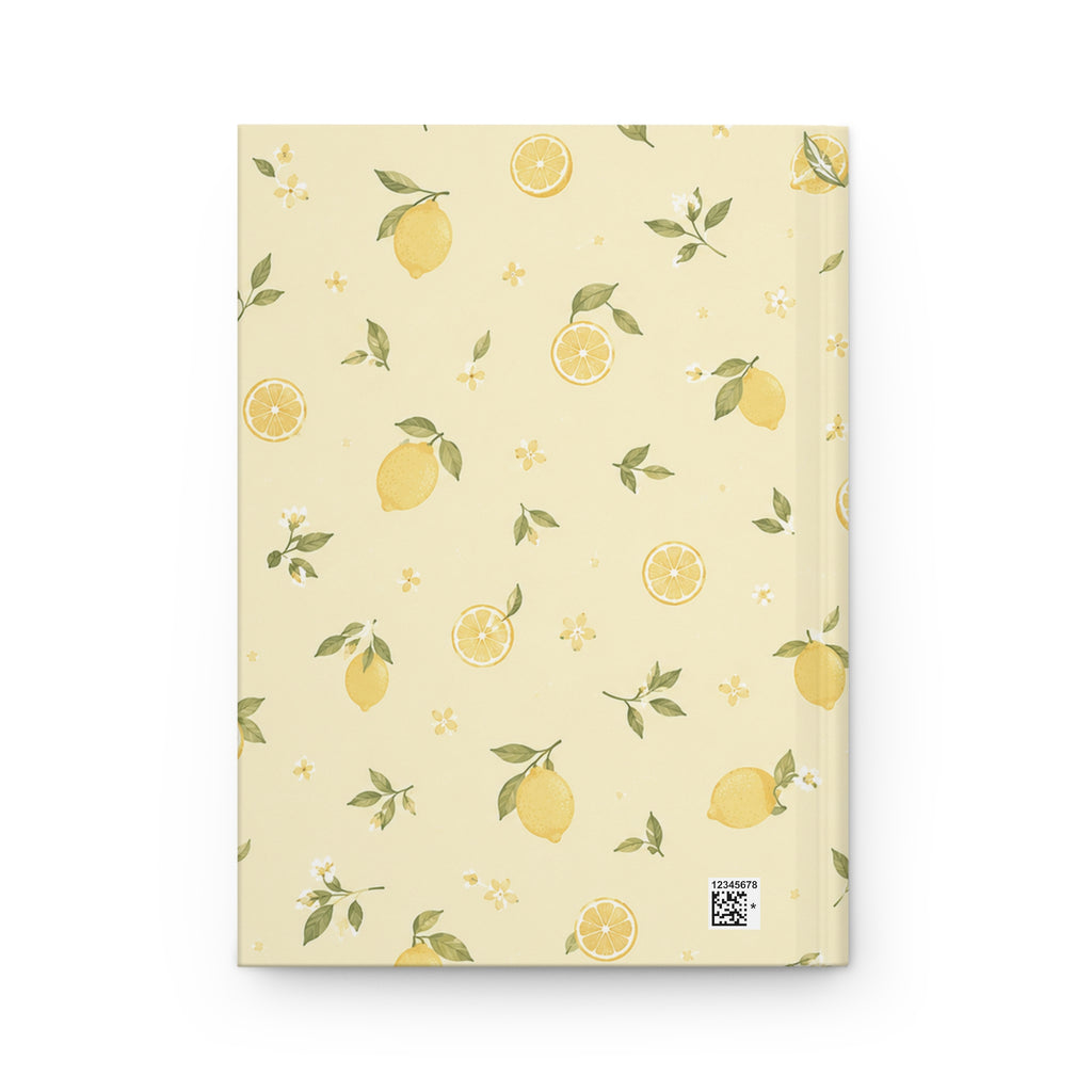 Lemon Blossom journal styled on a wooden desk with coffee and pen, flat lay