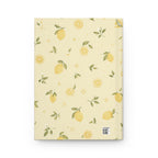 Lemon Blossom journal styled on a wooden desk with coffee and pen, flat lay