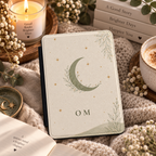 Close-up of the leaf-wrapped crescent moon and monogram lettering