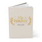 Close-up of the My Person journal cover showing gold laurel and heart detail with personalized name