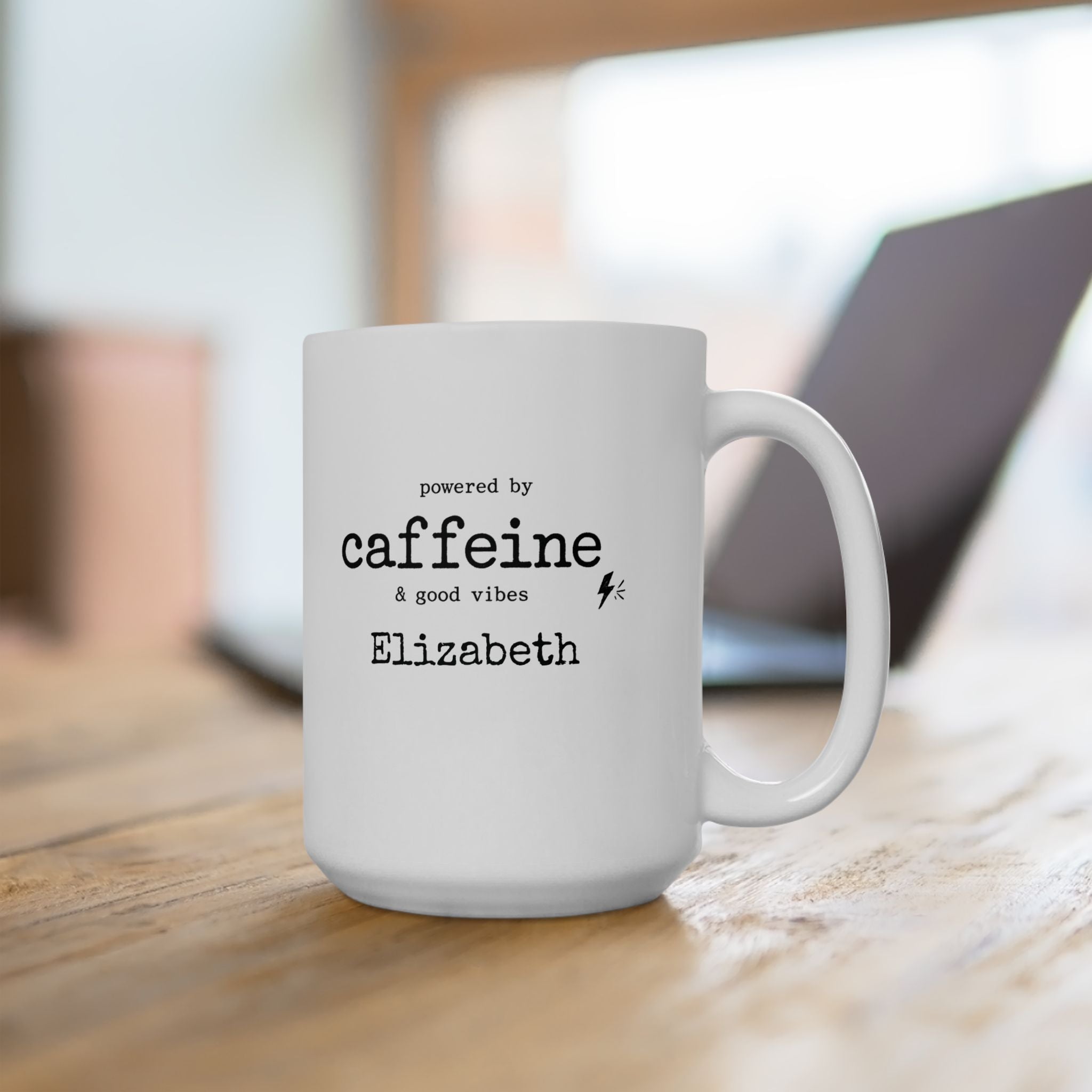 Personalized Powered by Caffeine mug styled on a desk with coffee