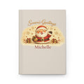 Season's Greetings personalized journal open flat showing custom name on cream cover with Santa illustration