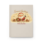 Season's Greetings personalized journal open flat showing custom name on cream cover with Santa illustration