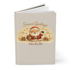 Close-up of the Season's Greetings journal cover showing Santa illustration and personalized name