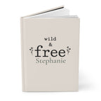 Close-up of the Wild & Free journal cover showing botanical typography and personalized name