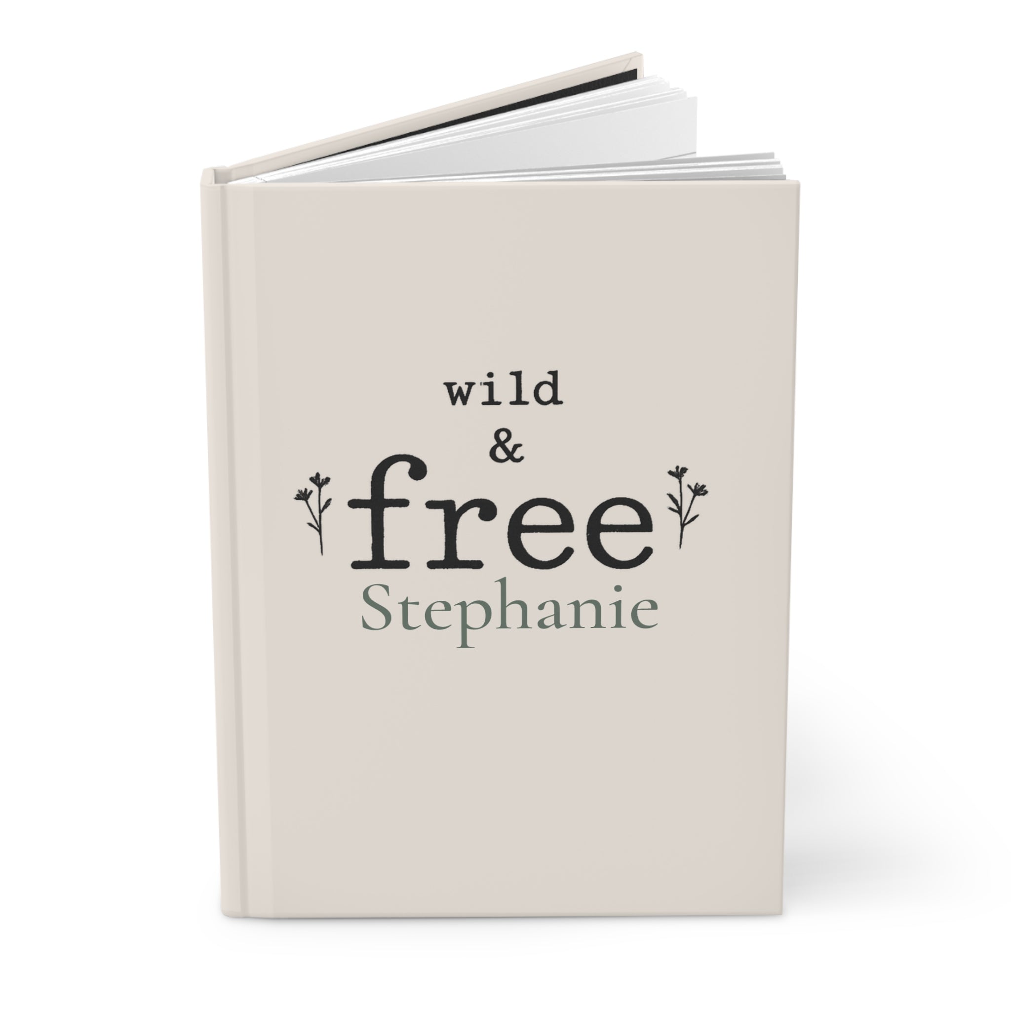 Close-up of the Wild & Free journal cover showing botanical typography and personalized name
