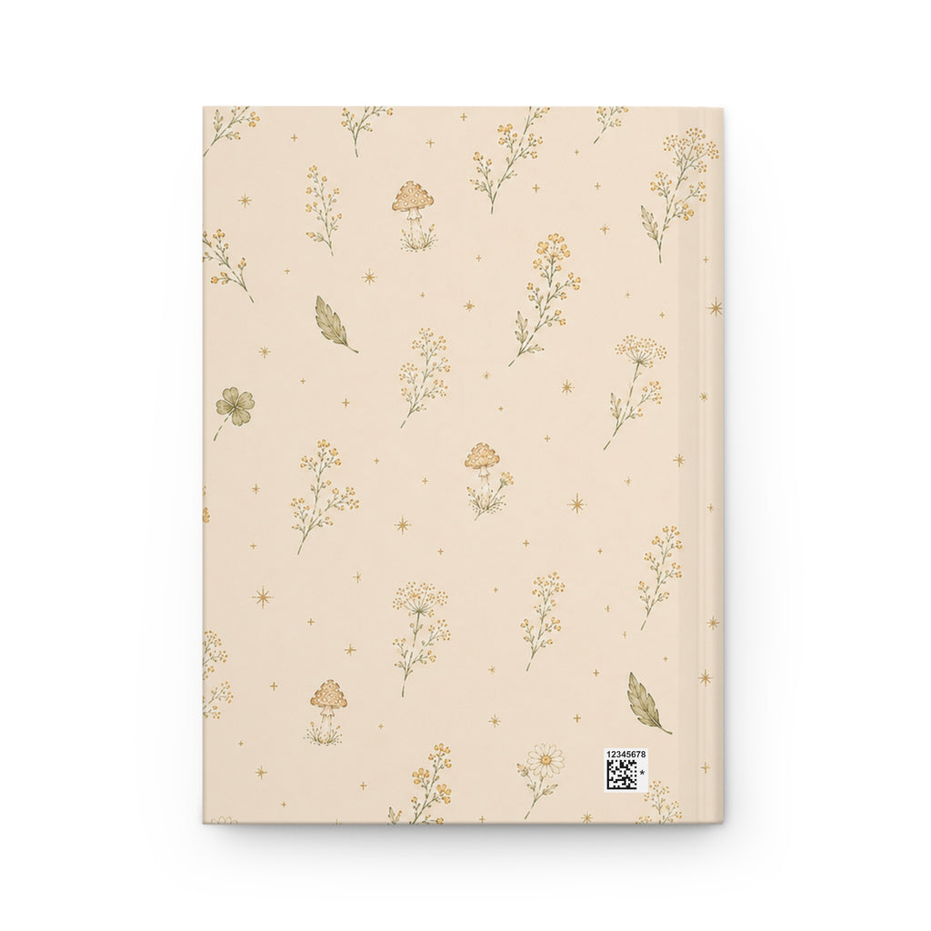 Wildflower and Mushroom journal styled on a wooden desk with coffee and pen, flat lay