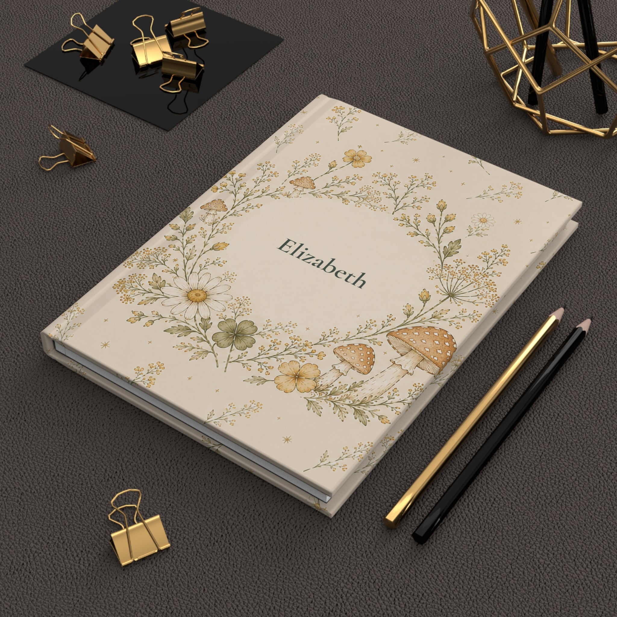 Wildflower and Mushroom journal held in hand to show size and portability