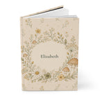 Close-up of the Wildflower and Mushroom journal cover showing botanical illustration and personalized name